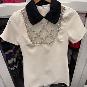 Elegant Cream Top with Black Collar and Embellishments